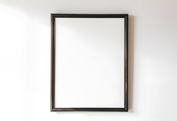 A black picture frame with a plant next to it on a white background