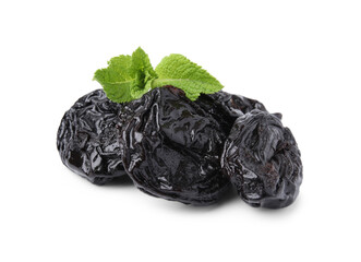 Tasty dried plums (prunes) and mint leaves isolated on white