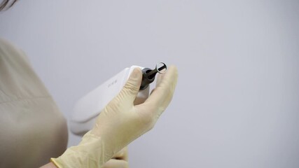 Doctor prepare to laser facial treatment. A woman undergoes a rejuvenating peel with a carbon mask, promoting skincare and reducing pigmented lesions. Female face cosmetic. Beauty aps