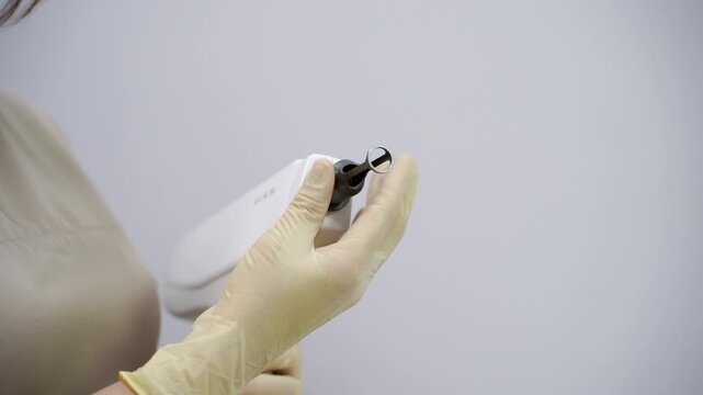 Doctor prepare to laser facial treatment. A woman undergoes a rejuvenating peel with a carbon mask, promoting skincare and reducing pigmented lesions. Female face cosmetic. Beauty aps