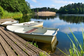 Obraz premium Three plastic boats. Summer holiday by the water.