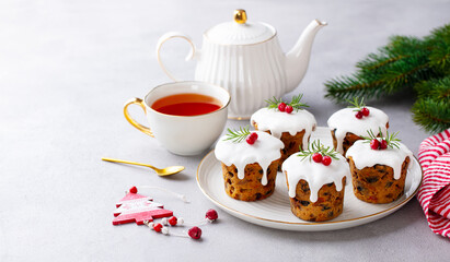 Christmas puddihgs, cakes with tea. Traditional dessert. Grey background. Copy space.