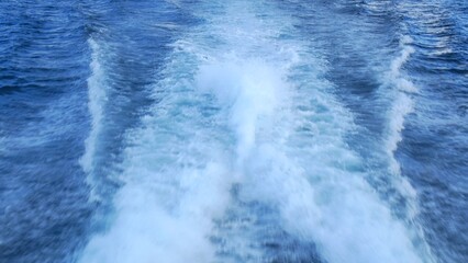 Boat wake in serene blue ocean, capturing essence of peaceful water journey. Perfect for enjoying tranquility, natural beauty, and sense of freedom that comes with open water travel. 