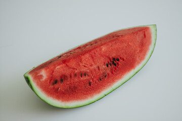 a large cut piece of juicy and sweet watermelon in the kitchen in the summer hot day