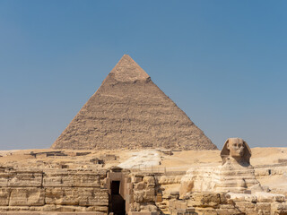 The great sphinx of Giza next to the Pyramid of Kefren in El Cairo Egypt