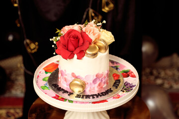 Celebration birthday cake decorated with white drip icing, buttercream frosting swirls, colorful sugar sprinkles and text on cake is Happy birthday cute saman 3rd feb
