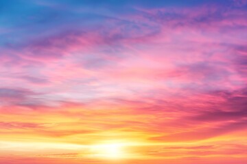 A beautiful sunset with a bright orange sun in the sky. The sky is filled with clouds and the colors are vibrant and warm