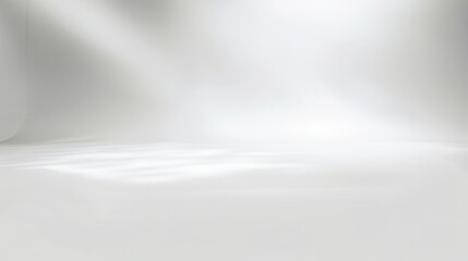 Obraz premium A serene white background with soft light. Ideal for showcasing products or creating a minimalist atmosphere in photography.