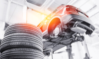 Car wheel service garage, changing winter tire on machine at station