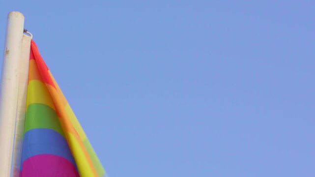 LGBTQ pride, gay, LGBTQ+ flag moving with wind clear blue sky vivid colors no people outdoors outside bright Lanzarote Canary Islands Spain free thinking liberal fight windy sunny one liberalism proud