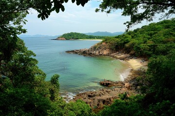 Fototapeta premium view from the top of a rocky beach, the sea is calm and flat with some small waves