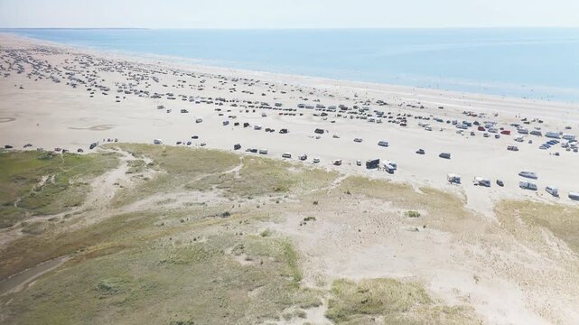 Drone video of the beach on Romo island covered by the campervans