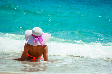 A Happy girl on the shore of the sea in travel vacation