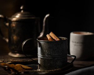 mulled wine, tea in an old vintage silver teapot and a vintage mug with cinnamon