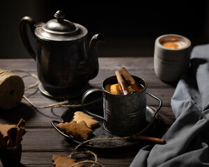mulled wine, tea in an old vintage silver teapot and a vintage mug with cinnamon