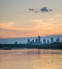 Warsaw skyline seen from the perspective of Vistula river in the colorful sunset.
