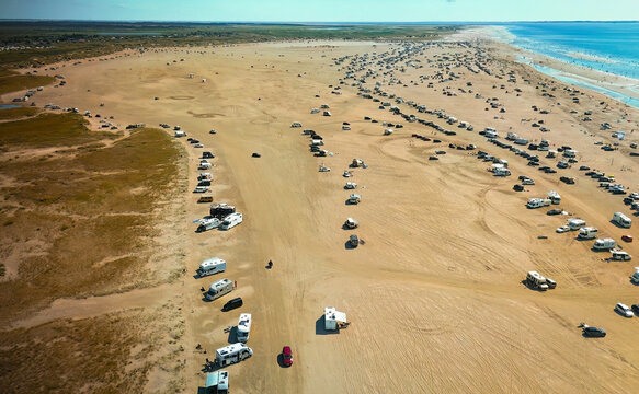 Aerial photo of the dozens of campers parking on the sandy beach of Romo, Denmark.