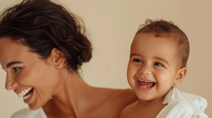 Loving bond of a Brazilian mother and her smiling baby, captured in a light-filled studio setting.