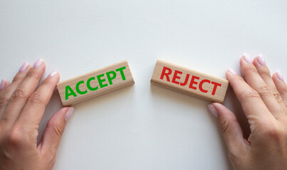 Accept or Reject symbol. Concept word Accept or Reject on wooden blocks. Businessman hand. Beautiful white background. Business and Accept or Reject concept. Copy space