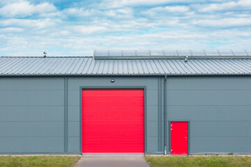 industrial hall with red raised doors 