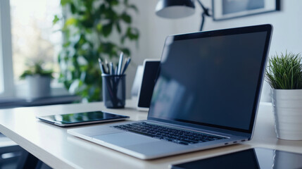 work-from-home setup, neat desk set up with laptop, tablet, and headphones for a productive remote work setup, promoting focus and efficiency while working from home