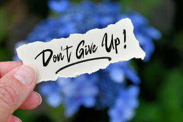 Handwritten note that says Don't Give Up - offering encouragement