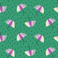 Colored umbrellas on a green background. Pattern with umbrellas