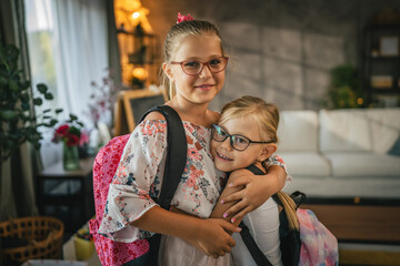 Portrait of young girls children with backpack, ready for school