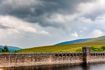 Grwyne Fawr reservoir dam wall on a stormy, wet summers day