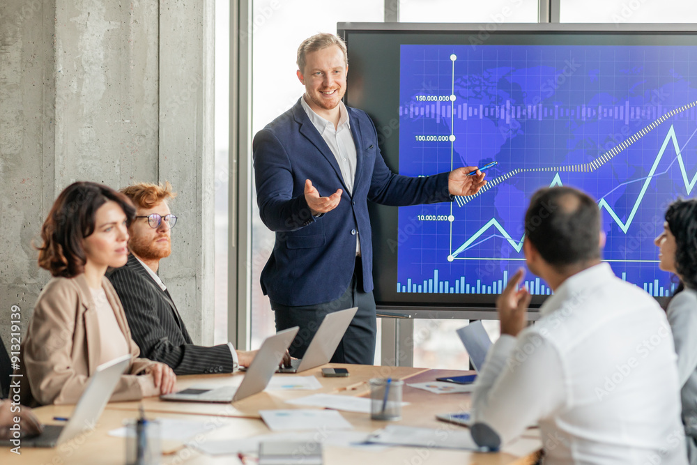 Poster A confident businessman in a blue suit stands in front of a large screen displaying a blue and white graph. The graph shows a strong upward trend with a rising line, suggesting positive growth