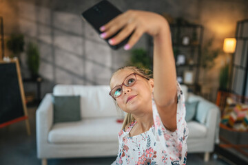 Self portrait or video call of young girl at home