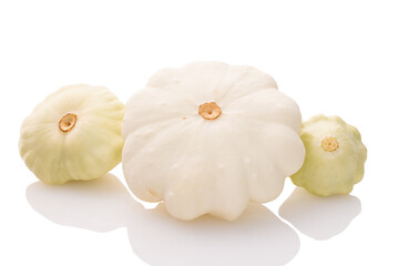 three young and fresh white pattypan squashes