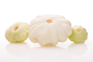 three young and fresh white pattypan squashes