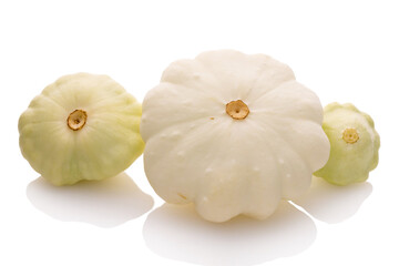 three young and fresh white pattypan squashes