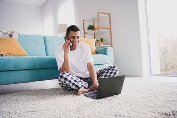 Photo of handsome good mood guy nightwear pajama having rest talking modern gadgets indoors room...