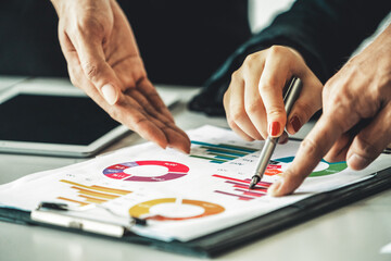 Businessman and businesswoman in meeting working with many financial statement document on desk....