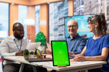Senior man and woman meeting with advisor in modern office, isolated chroma key screen on laptop. Financial expert helping clients choose the suitable retirement plan for them.