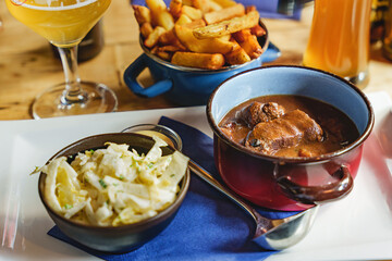 Belgian Goulash With Fries And Salad On Served Table