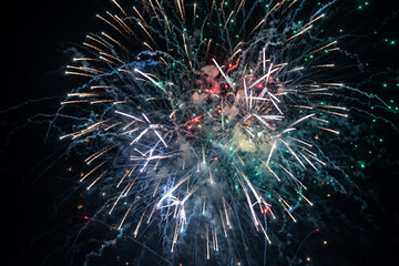 Holiday fireworks explode in the night sky. Selective focus. 