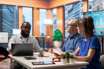 Elderly couple receiving professional advice from a financial planner on retirement and pension options for future stability. Mature couple meeting with advisor to explore various plans.