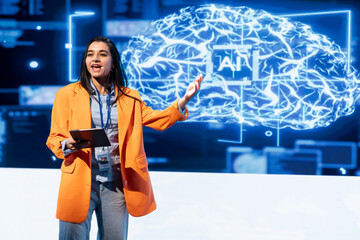 Cheerful manager holding tablet speaking at event bringing together leading researchers to explore developments in AI and machine learning. Smiling professional using device to hold tech presentation
