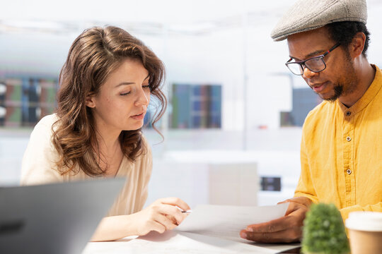 Realtor broker negotiating leasing contract terms during an office tour, preparing to sign the paperwork. Female entrepreneur investing in high class real estate building. Office hunt.
