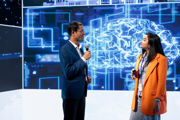 Speaker interviewing guest during presentation, exploring ways emerging AI technologies can enhance...