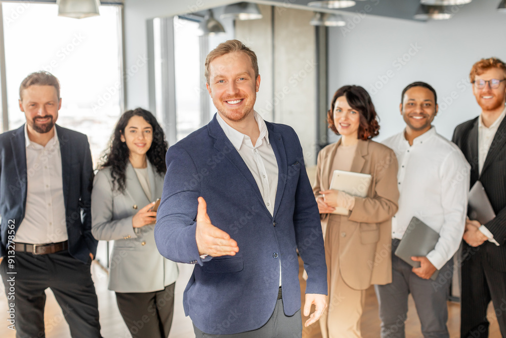 Aufkleber a group of diverse business professionals are standing in a modern office, with one man extending hi