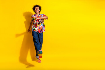 Full body portrait of nice funky young man walk dance empty space wear shirt isolated on vibrant yellow color background