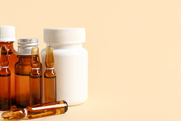Ampules and bottles with medicines on beige background