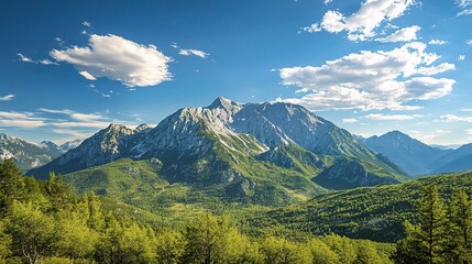 Fototapeta premium Majestic Mountain Vista: A breathtaking panorama of a towering mountain range, bathed in sunlight, framed by vibrant green foliage and an expansive sky dotted with fluffy clouds.