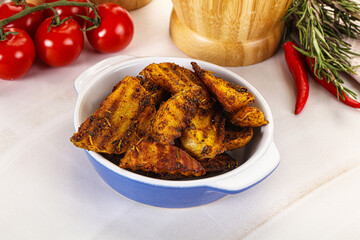 Golden baked potato Idaho with spices