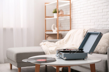 Interior of living room with sofa and record player on coffee table