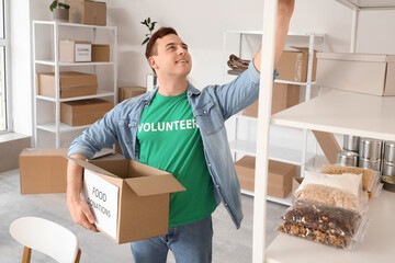 Male volunteer with food donations in center